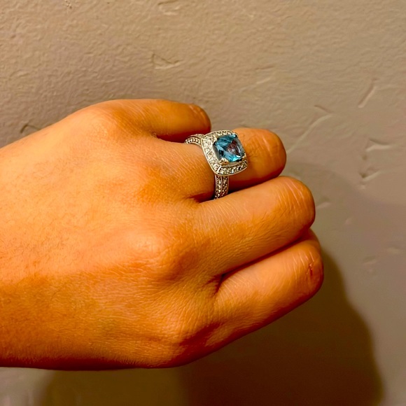 Diamond eternity band with blue topaz center stone